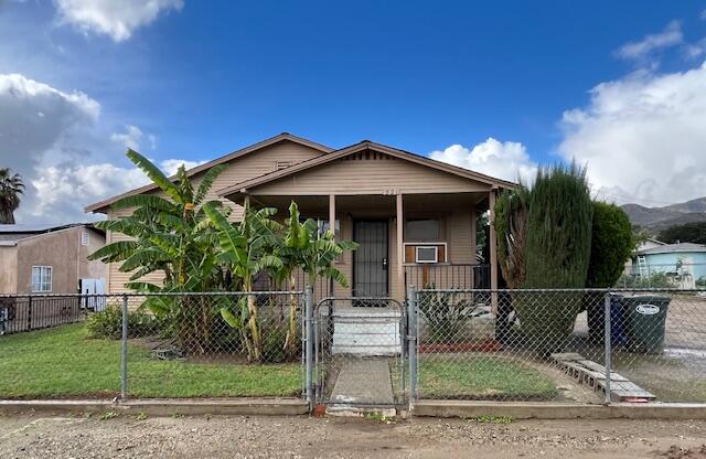 a front view of a house with plants