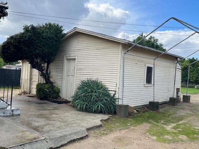 521 Temescal Street Piru, CA 93040 - Photo 5 of 16 a small white house with a white roof and table and chairs next to window