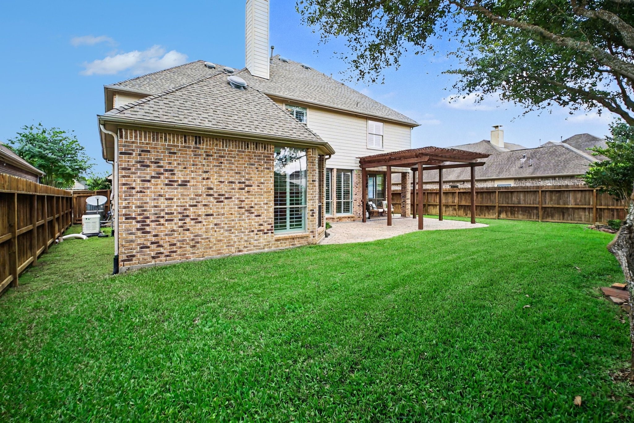 8210 Thunder Ridge Way Missouri City, TX 77459 - Photo 21 of 42 This backyard features a full-house generator and newly replaced wooden fences, offering reliability and privacy.