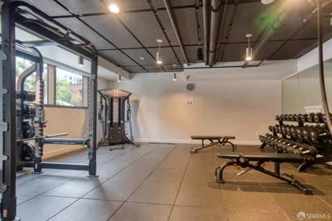 a view of a roof deck with table and chairs