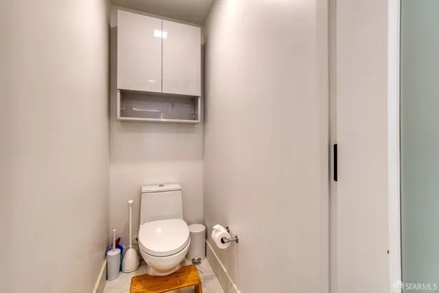 a view of a hallway with wooden shelves