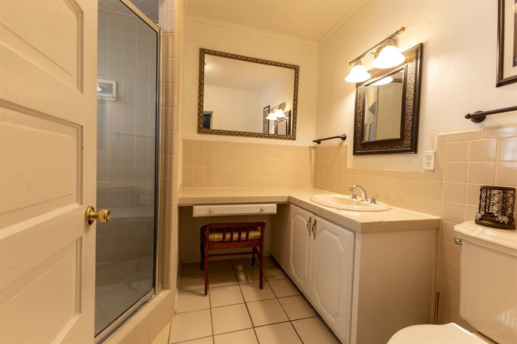 1115 Austin Street Coleman, TX 76834 - Photo 16 of 40 a bathroom with a sink and a mirror