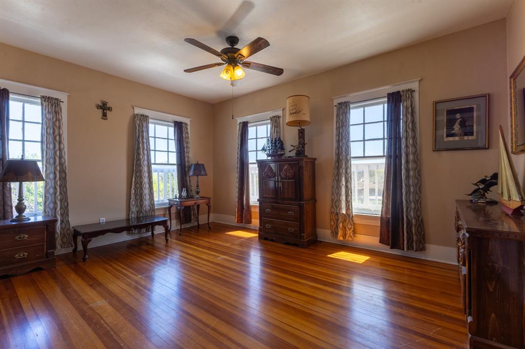 1115 Austin Street Coleman, TX 76834 - Photo 20 of 40 a view of an empty room with window and wooden floor