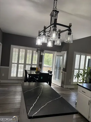 a view of a dining room with furniture wooden floor and chandelier