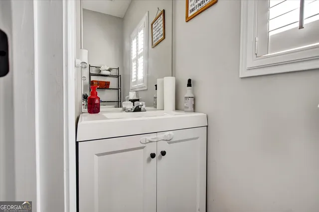 a bathroom with a sink and a mirror