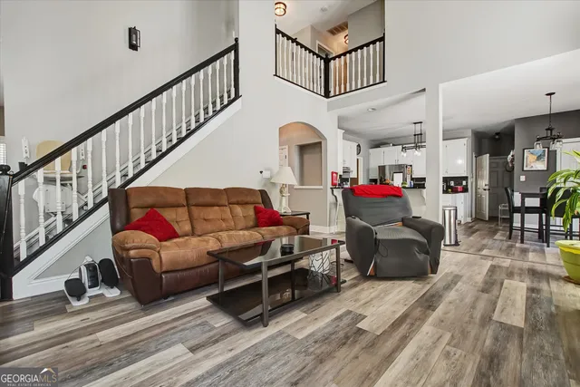 a living room with furniture and a wooden floor