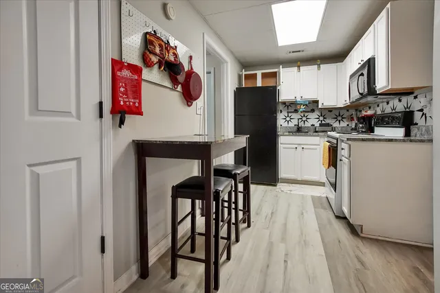 a bedroom with a bed and a mirror on dresser