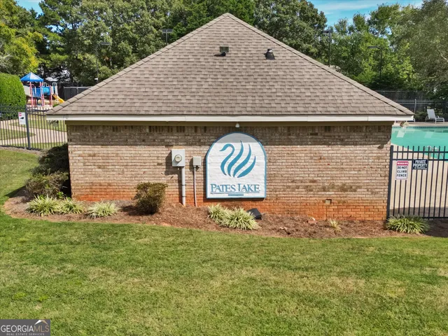 a view of a backyard with wooden fence