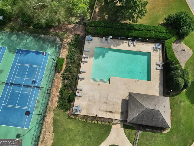 swimming pool view with a seating space