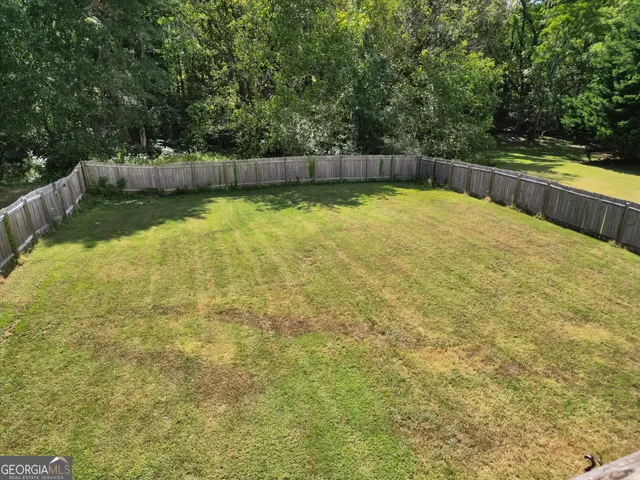 a swimming pool that is in the middle of a yard