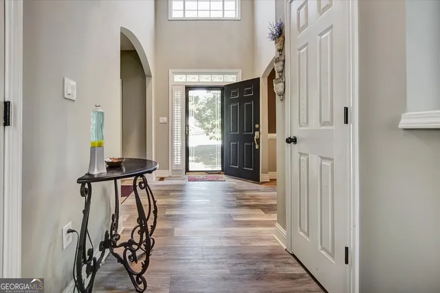 a view of a room with wooden floor and windows