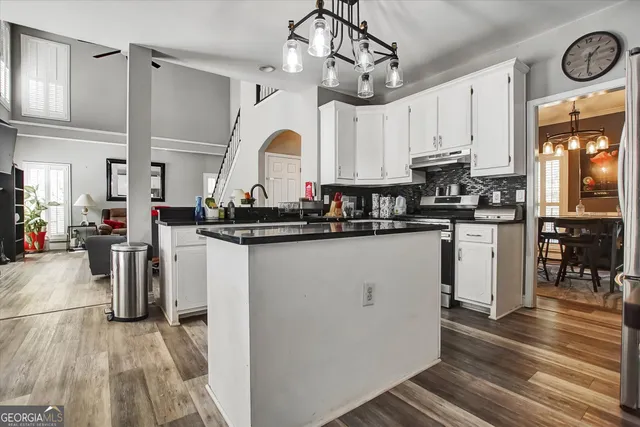 a kitchen with a refrigerator and a stove top oven
