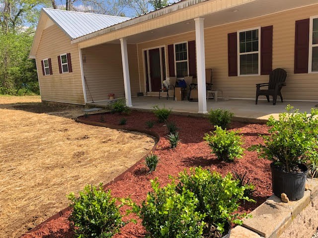 176 McLemore Road Ardmore, TN 38449 - Photo 1 of 9 a front view of a house with a yard and potted plants
