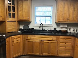 176 McLemore Road Ardmore, TN 38449 - Photo 4 of 9 a kitchen with stainless steel appliances granite countertop a sink and cabinets with wooden floor