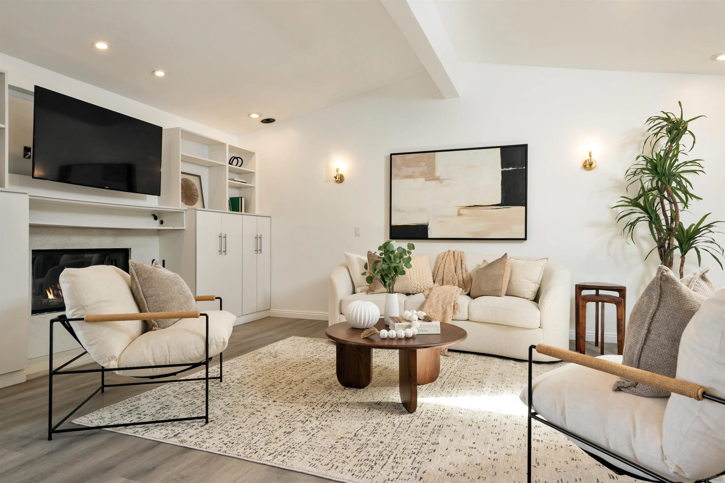 2015 Ainsley Road San Diego, CA 92123 - Photo 13 of 54 a living room with furniture a flat screen tv and a fireplace