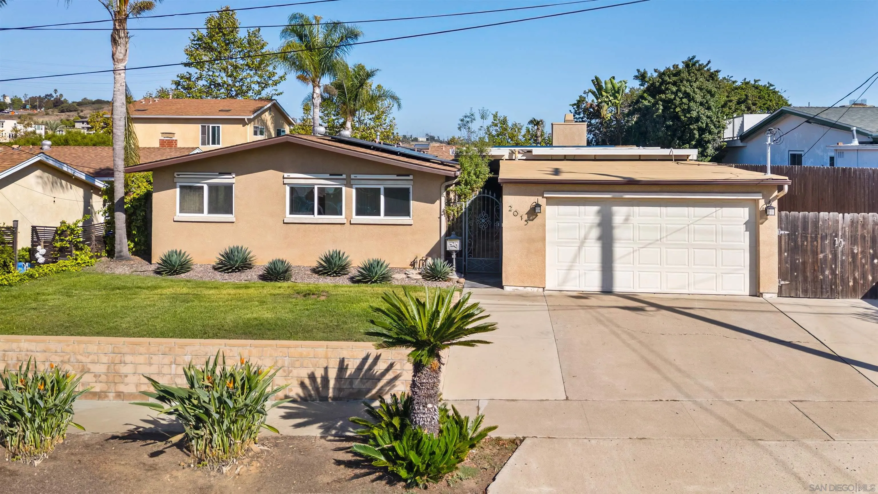 2015 Ainsley Road San Diego, CA 92123 - Photo 44 of 54 a front view of a house with a garden