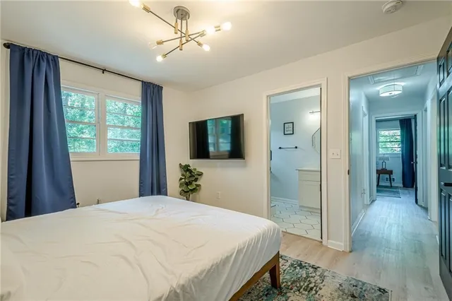 a bedroom with a bed and a chandelier