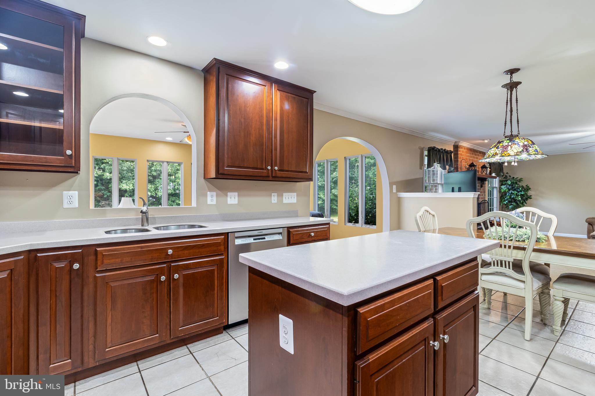 203 Morgans Ridge Court La Plata, MD 20646 - Photo 17 of 59 a kitchen with a stove a sink a microwave a dining table and chairs