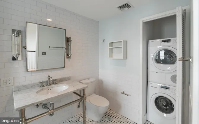 an empty room with wooden floor ceiling fan and windows