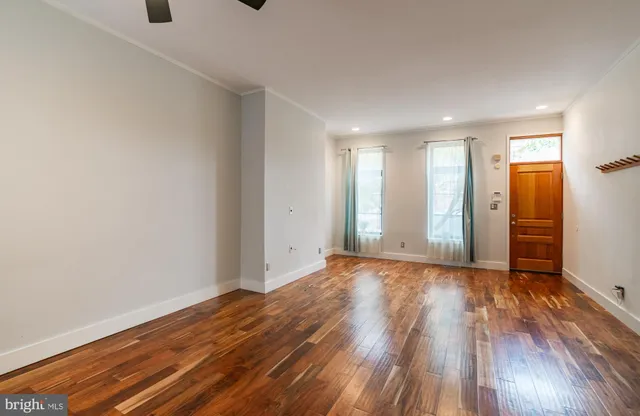 a view of an empty room and wooden floor
