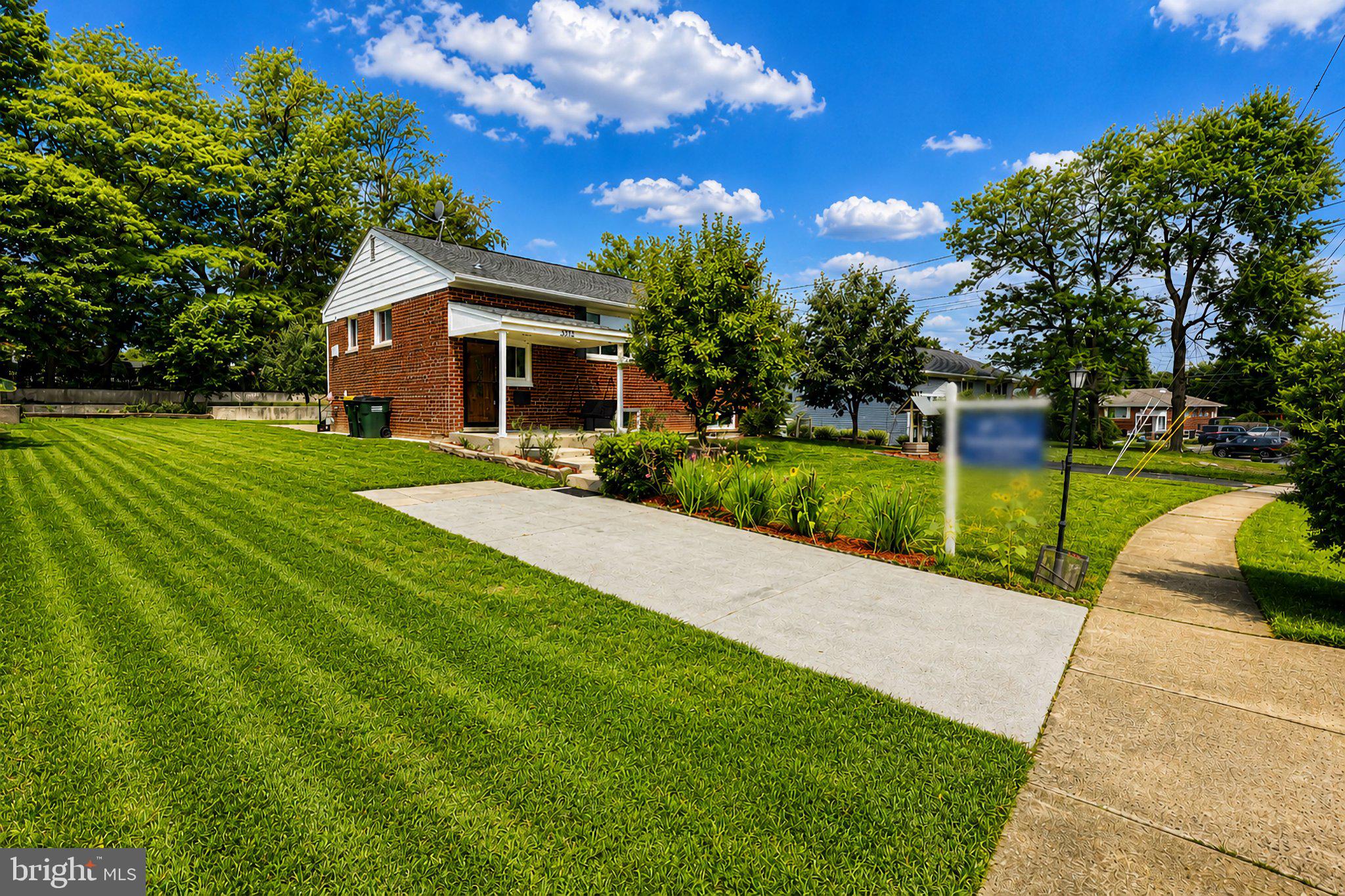 5712 Ash Drive Springfield, VA 22150 - Photo 1 of 38 Charming home with lush green lawn.