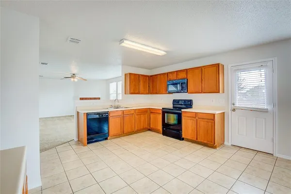 a kitchen with stainless steel appliances granite countertop a sink and cabinets