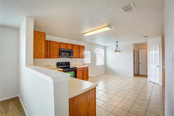 a kitchen with stainless steel appliances a stove a microwave and a refrigerator