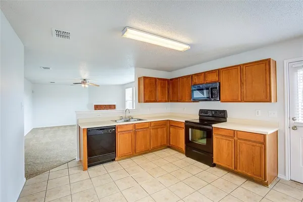 a kitchen with stainless steel appliances granite countertop a stove sink and cabinets
