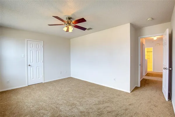 a view of a livingroom with a ceiling fan and window