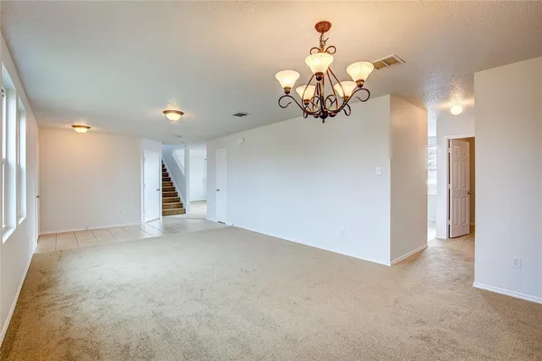 a view of a chandelier in big room and chandelier