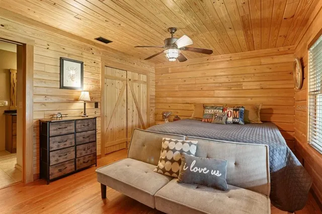 a large bed sitting in a bedroom next to a window