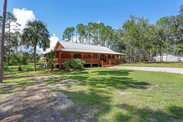 a front view of house with yard and green space