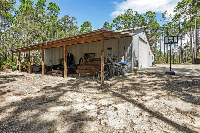 a front view of a house with a yard and tree s