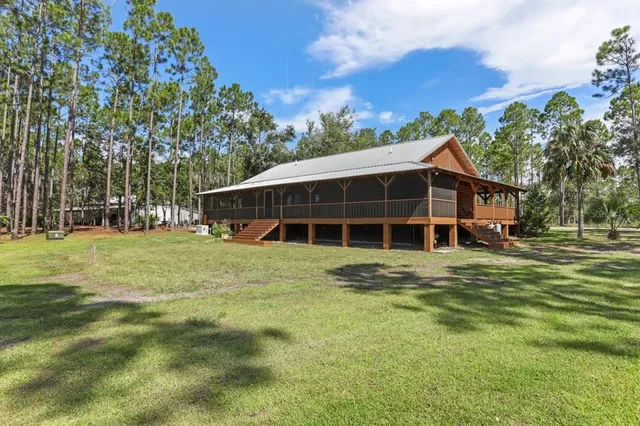 a view of a house with a backyard