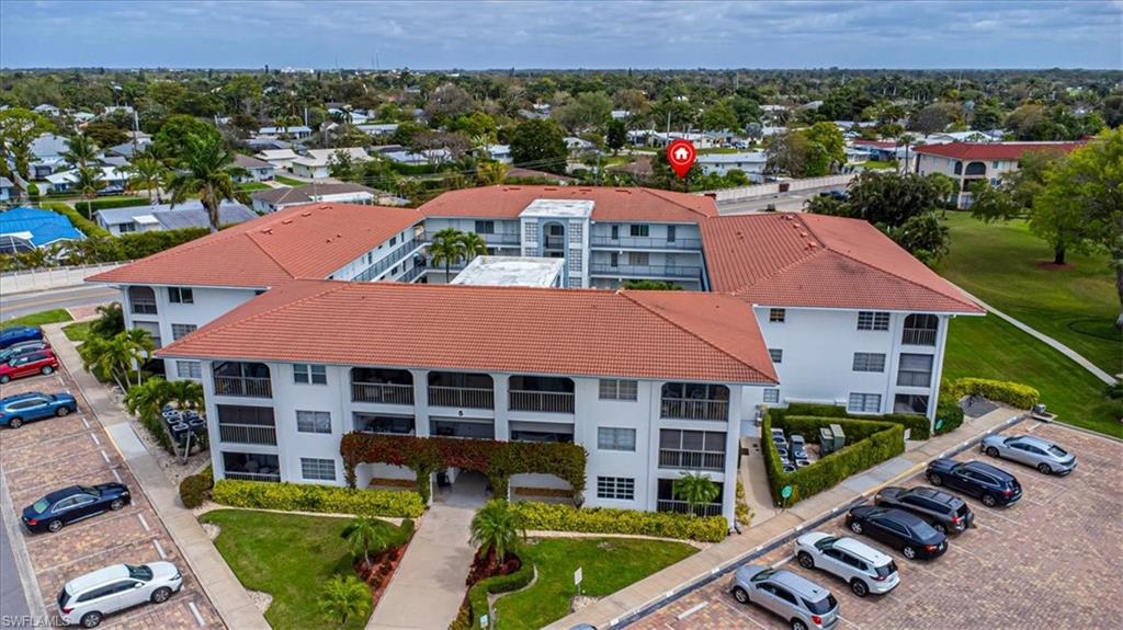 5 High Point Circle West, Unit 308 Naples, FL 34103 - Photo 1 of 28 an aerial view of multiple houses with a yard