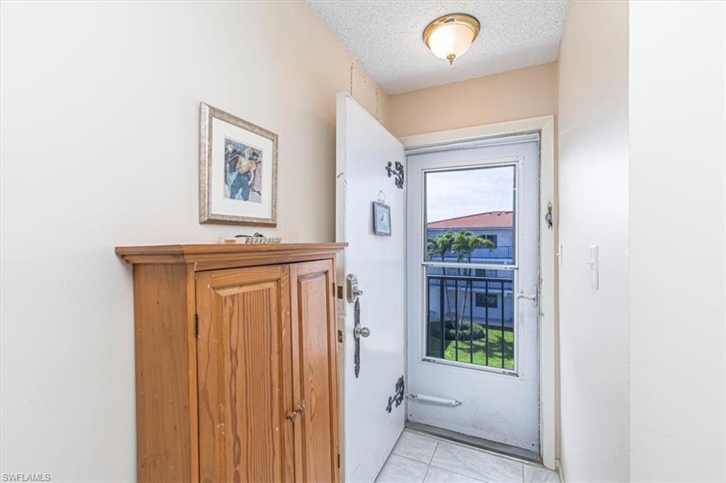 5 High Point Circle West, Unit 308 Naples, FL 34103 - Photo 17 of 28 a view of a hallway to rooms