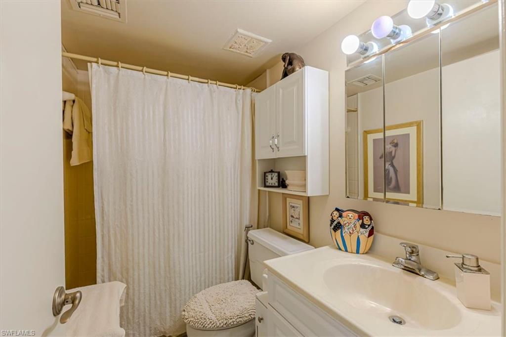 5 High Point Circle West, Unit 308 Naples, FL 34103 - Photo 19 of 28 a bathroom with a sink toilet and shower