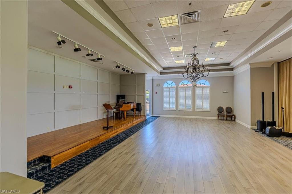 5 High Point Circle West, Unit 308 Naples, FL 34103 - Photo 24 of 28 a very nice looking room with wooden floor and a ceiling fan