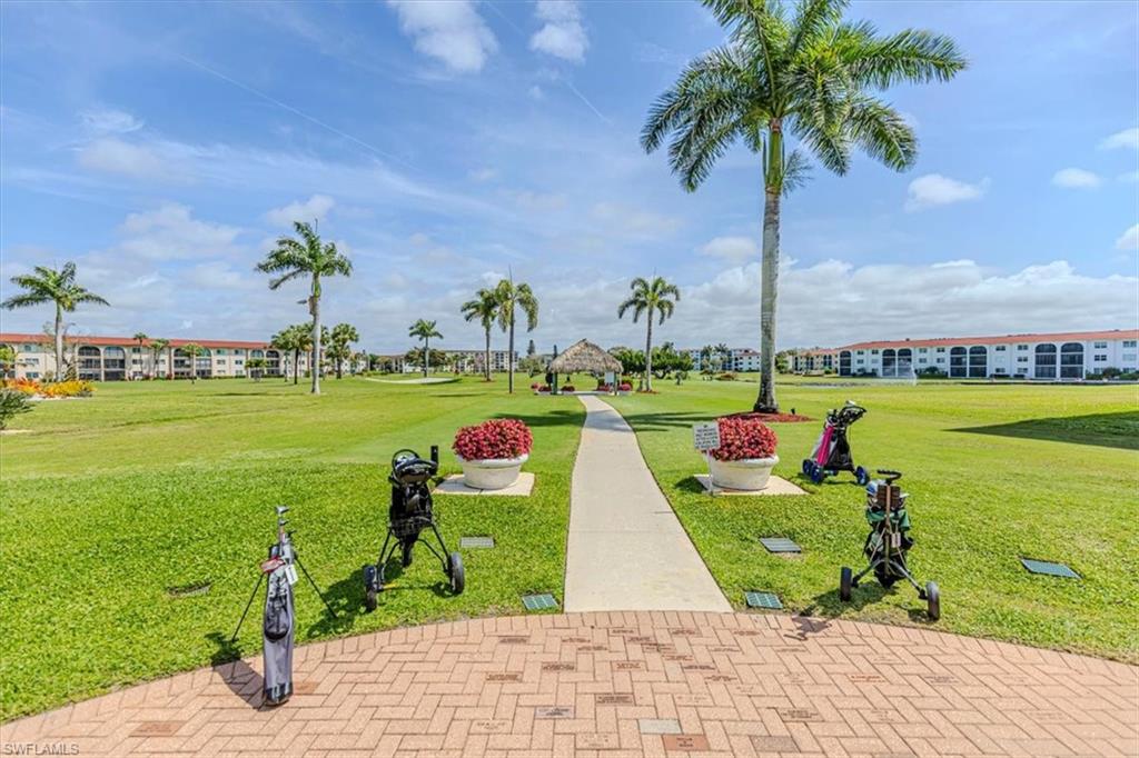 5 High Point Circle West, Unit 308 Naples, FL 34103 - Photo 27 of 28 a view of a lake with a big yard