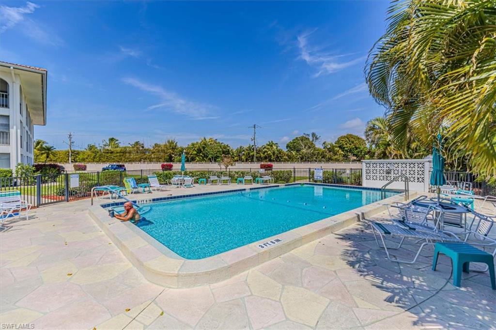 5 High Point Circle West, Unit 308 Naples, FL 34103 - Photo 28 of 28 a view of swimming pool with outdoor seating and plants