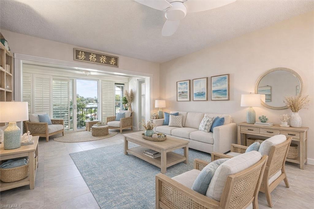 5 High Point Circle West, Unit 308 Naples, FL 34103 - Photo 6 of 28 a living room with furniture and a large window