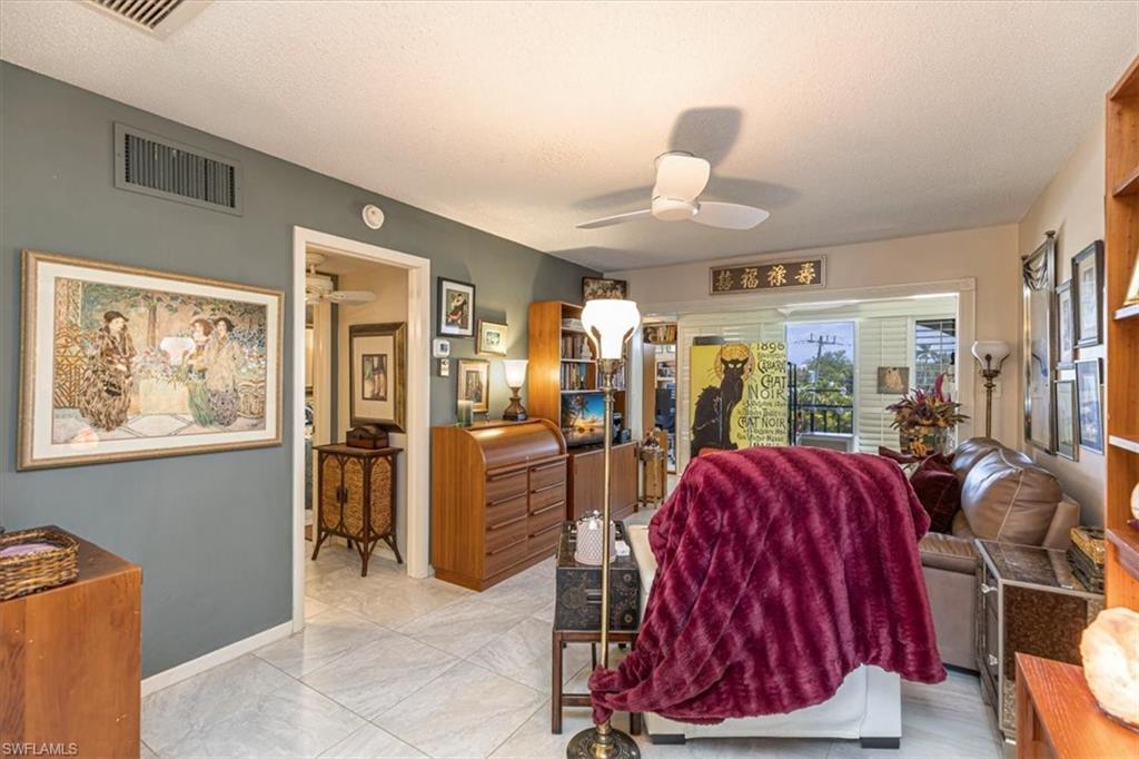 5 High Point Circle West, Unit 308 Naples, FL 34103 - Photo 9 of 28 a view of a livingroom with furniture and window