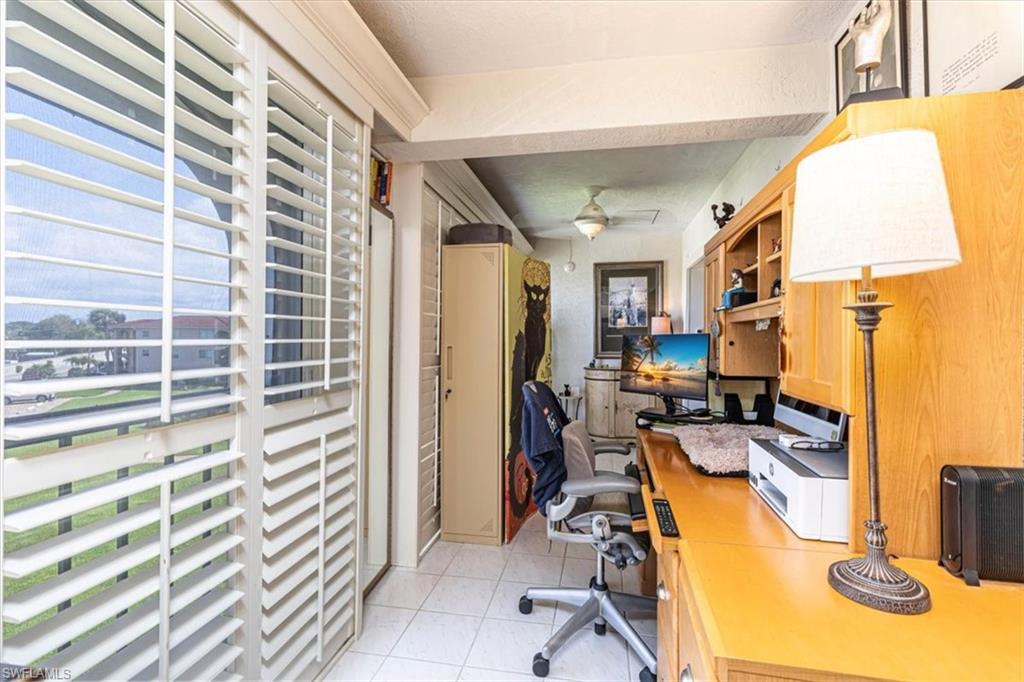5 High Point Circle West, Unit 308 Naples, FL 34103 - Photo 10 of 28 a view of a livingroom with workspace and a window