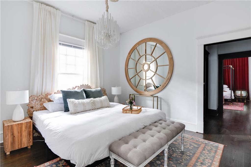 950 Austin Avenue Northeast Atlanta, GA 30307 - Photo 3 of 32 a bedroom with a bed a mirror and a window