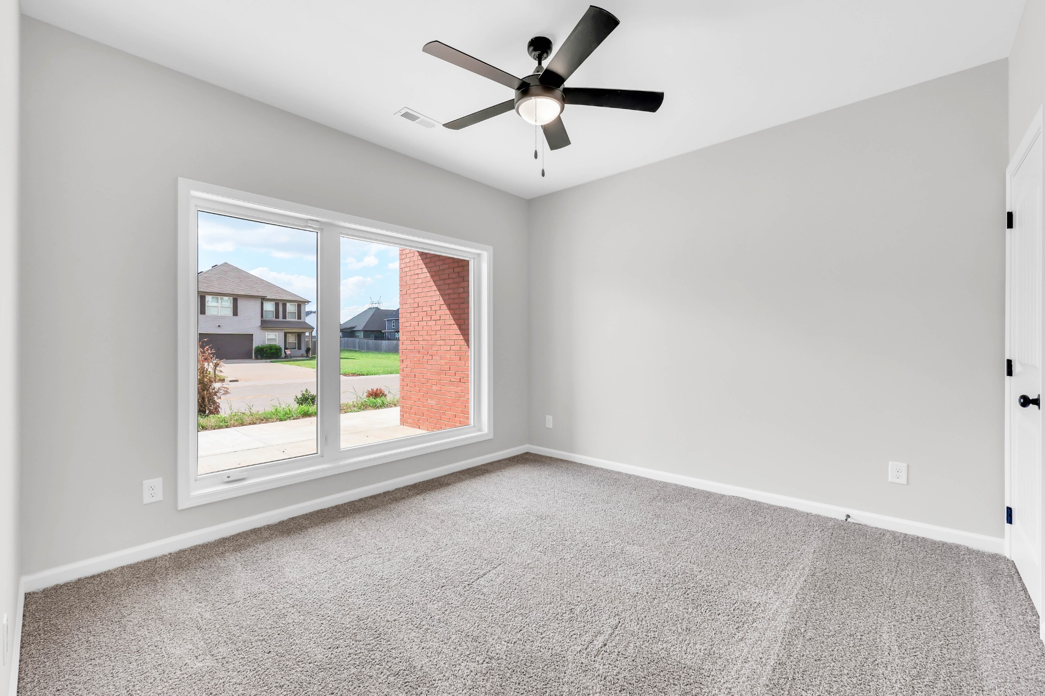 2395 Pea Ridge Road Clarksville, TN 37040 - Photo 27 of 36 an empty room with windows and ceiling fan