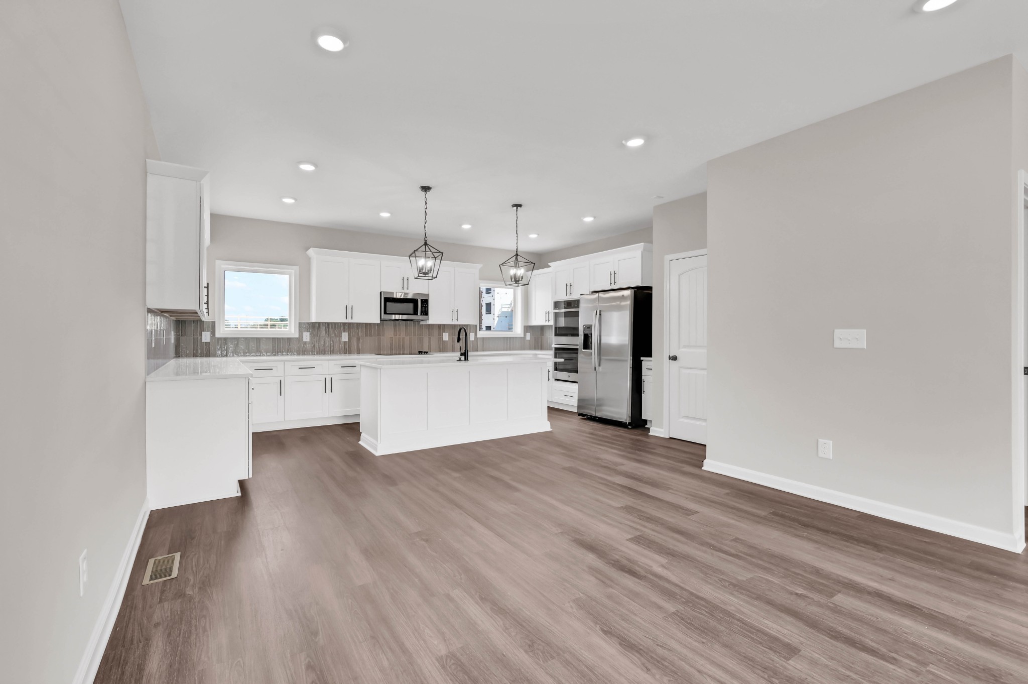 2395 Pea Ridge Road Clarksville, TN 37040 - Photo 7 of 36 a large kitchen with stainless steel appliances kitchen island a large counter top and a sink