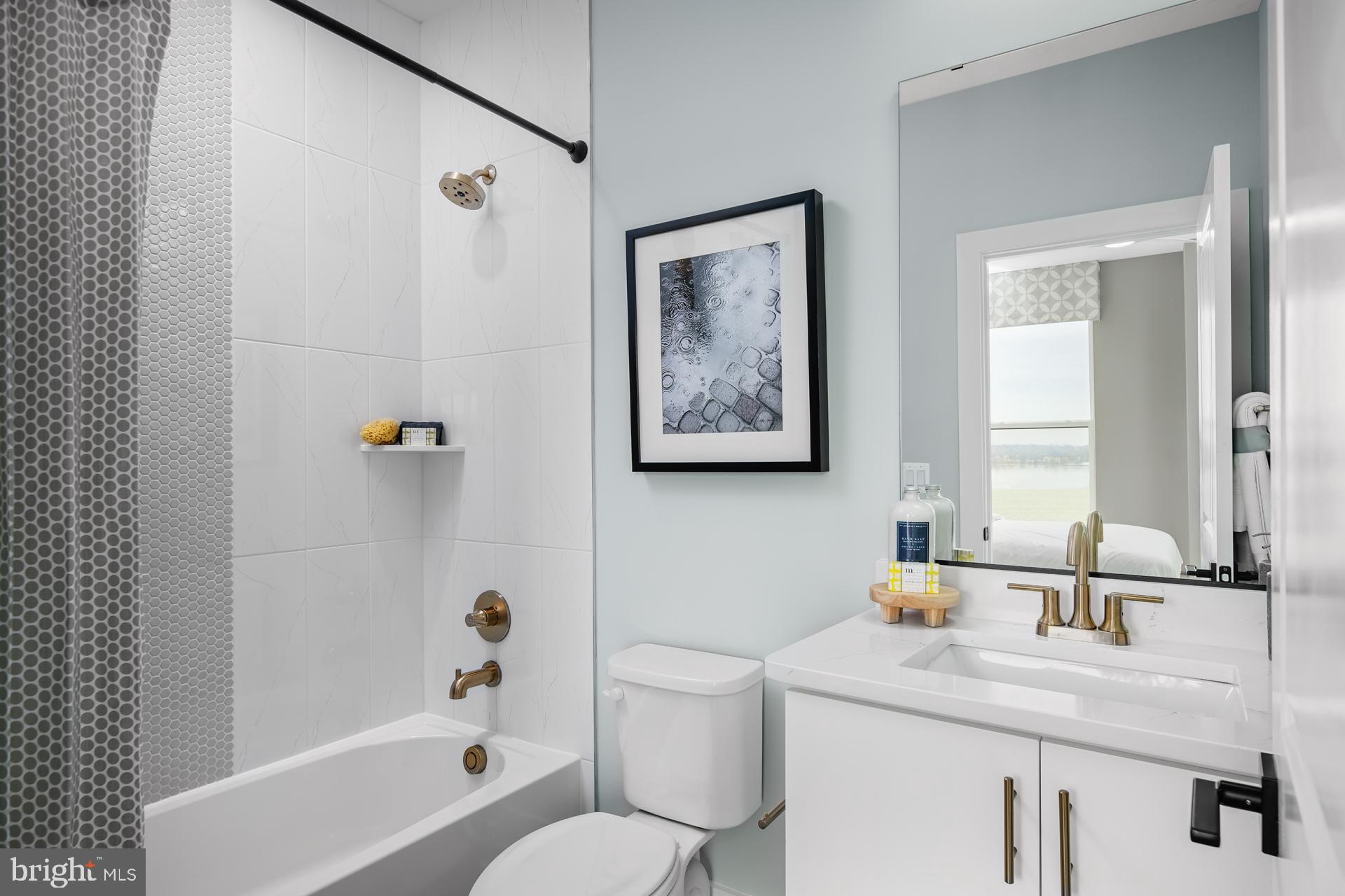 280 Light Street Baltimore, MD 21230 - Photo 17 of 26 a bathroom with a granite countertop sink a toilet and shower