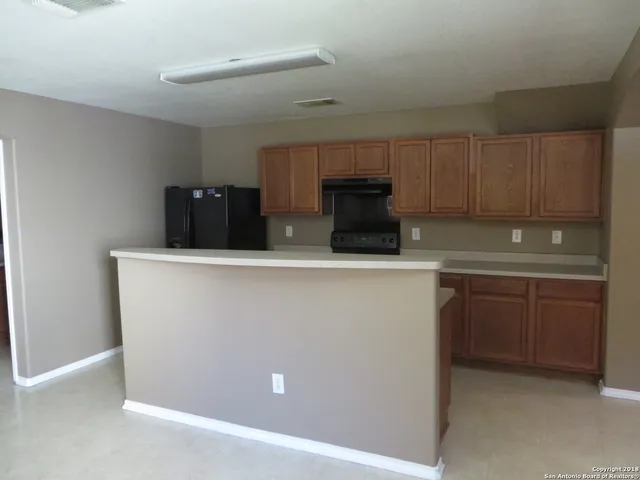 a kitchen with stainless steel appliances a refrigerator sink and cabinets