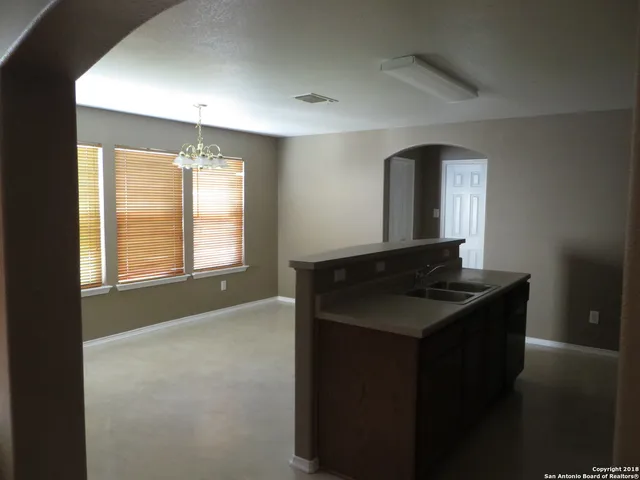 a bathroom with a granite countertop sink a mirror and a bathtub