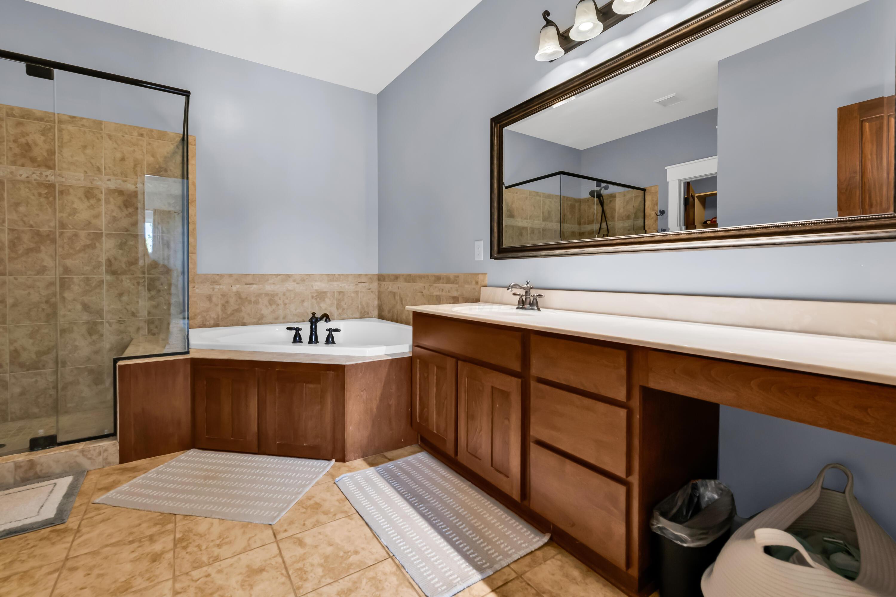 16689 Bailor Road Laurelville, OH 43135 - Photo 14 of 73 • Ceramic tile flooring
• Grey painted walls
• Corner garden tub with
ceramic tile surround
• Enclosed vanity with single
bowl, cultured marble
sinktop & makeup area
• 4 bulb wall light
• Ceiling light
• Ceiling exhaust
• Shower stall with glass
enclosure &